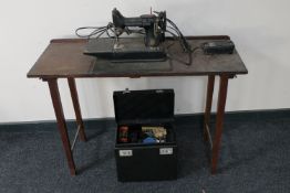 A Singer electric sewing machine on table