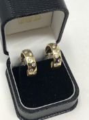 A pair of 18ct gold diamond set earrings, approximately 1.