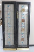 A pair of early twentieth century painted doors with leaded glass panels