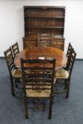 An oval oak farmhouse kitchen table and six ladder back chairs