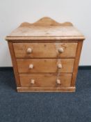An antique pine three drawer chest