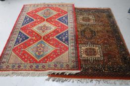 Two fringed Persian design rugs