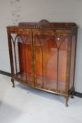 A 1930's walnut double door display cabinet