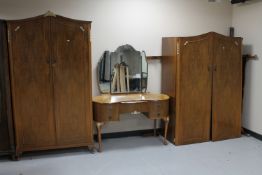 A three piece 1930's walnut bedroom suite comprising of lady's and gent's wardrobes and kidney