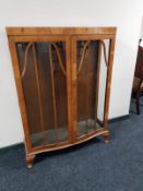 A 1930's walnut double door display cabinet