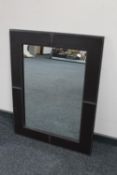 A contemporary leather framed mirror
