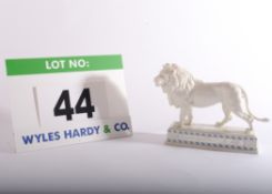A HUTSCHENREUTHER Porcelain Figurine of a Lion on a Plinth bearing engraved Plaque inscribed Zur