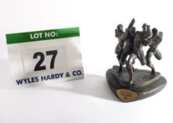 A Cast Bronze Trophy depicting Four Runners Stretching for the Finishing Line, Casting Mark 1975