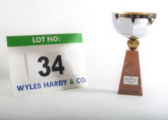 A Chromed Steel Cup on a Composite Marble Pedestal bearing an Engraved Plaque with the words 3.