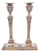 A pair of Victorian silver candlesticks, maker Hawksworth, Eyre & Co Ltd, Sheffield, 1880: crested,
