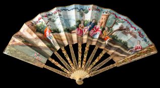 A 19th century French ivory painted fan: the paper leaf decorated with figures seated in a wooded