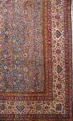 A Kerman carpet of large size:, the indigo field with an all over geometric design of palmettes,