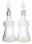 A pair of Victorian silver mounted and clear glass decanters, maker's marks worn, London,