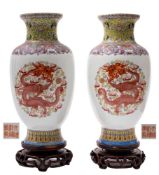 A pair of Chinese famille rose dragon vases: painted with dragons chasing gilt pearls amongst flame