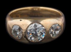 A gentleman's gypsy-set diamond three-stone ring: with central round diamond approximately 7.