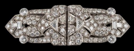 An Art Deco diamond encrusted double clip brooch: mille-grain-set with round,