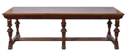 By James Shoolbred An Edwardian walnut dining table of refectory type:,