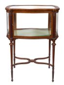An Edwardian mahogany and inlaid bijouterie display cabinet:, of serpentine outline,