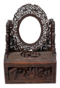 A Chinese carved wood toilet mirror: of arched outline,