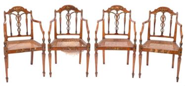 A set of four Sheraton period satinwood and decorated elbow chairs:, painted with floral foliage,
