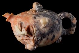 A Chinese carved soapstone teapot and cover: in the form of a pomegranate with stalk handle,