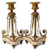 A pair of 19th century alabaster and gilt metal candlesticks: with urn-shaped nozzles,