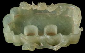 A Chinese carved nephrite brush washer: of scroll form, the rim carved with a chilong and lingzhi,