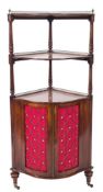 A late 19th Century mahogany serpentine fronted three tier corner whatnot/encoigneur:,