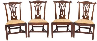 A set of four George III carved mahogany dining chairs in the Chippendale taste:,