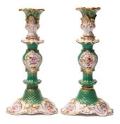 A pair of early 19th century English porcelain baluster candlesticks: each moulded with acanthus