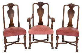 A set of six Edwardian carved oak dining chairs in the Queen Anne taste:,
