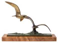 An Art Deco bronze group of seagulls: modelled flying above crested waves,