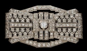 A French Art Deco diamond mounted rectangular plaque brooch: of pierced stylised ribbon bow design