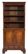 A mahogany upright bookcase:, the upper part with a moulded dentil cornice,