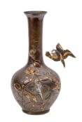 A Japanese bronze and inlaid vase: of ovoid form with long slender neck on a circular foot,