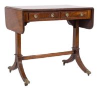 A mahogany sofa table in the Regency taste:, the hinged top with rounded corners and a reeded edge,
