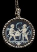 A 19th century circular portrait miniature pendant depicting cupids,