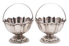 A pair of Edward VII silver swing handled bon bon baskets, maker A & J Zimmerman Ltd, Birmingham,