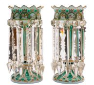 A pair of Bohemian green and white overlay glass lustres: of conventional form hung with prismatic