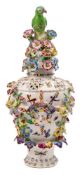 A Bow frill vase and cover: of traditional pierced form with bird finial, applied with female masks,