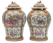A pair of 19th century Canton famille rose/verte baluster jars and covers: each with gilt lion dog