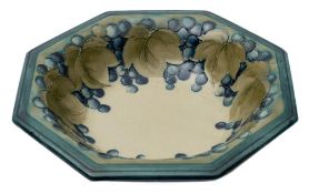 A Moorcroft pottery octagonal bowl: tube lined and decorated with a design of leaves and fruit