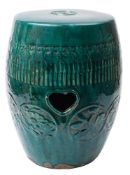 A Chinese green-glazed earthenware garden seat: of barrel form moulded with floral medallions and