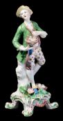 A Bow figure of a youth representing 'Liberty': holding a nest of young birds and wearing a yellow