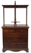 A Georgian oak linen press:, the superstructure with a central spiral thread,