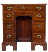 A mid 18th Century mahogany kneehole desk:, of small size, the top with a moulded edge,