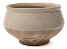 A Chinese Cizhou stoneware bowl: with rolled rim, rounded sides and short cylindrical footrim,
