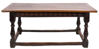 A 17th Century oak dining table of refectory type:, with a rectangular plank top,