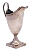 A George III silver cream jug, maker's mark worn, London, 1809: of helmet-shaped outline,