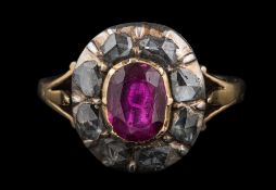 An antique gold, ruby and diamond oval cluster ring: the central oval ruby approximately 7.